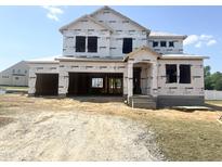 New construction home featuring a large attached garage with a covered front porch at 139 Fast Pitch Ln, Four Oaks, NC 27524
