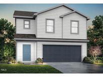 Charming two-story home featuring a blue front door and a two-car garage at 209 Lillian Ct, Roxboro, NC 27573