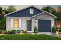 Charming single-story home featuring vinyl siding, a gray front door, and a well-manicured lawn at 224 Landon Pl, Roxboro, NC 27573
