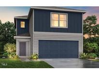 Charming two-story home with a gray trim, dark blue siding, and a two-car garage at 250 Landon Pl, Roxboro, NC 27573