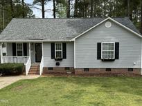 Charming single-Gathering home with gray siding, manicured lawn, and lovely curb appeal at 308 Caroline Dr, Wendell, NC 27591
