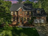 Beautiful brick home with a two-car garage and lush landscaping at 308 Sunset Creek Cir, Chapel Hill, NC 27516