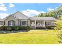 Charming one-story home with covered porch and well-manicured landscaping at 3604 Stagecoach Rd, Durham, NC 27713