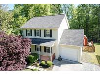 Charming two-story home with a front porch, attached garage, and well-maintained landscaping at 3819 Valleydale Dr, Durham, NC 27703