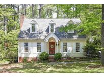 Charming cottage-style home with dormer windows, brick accents, and a landscaped front yard at 4 W Bridlewood Trl, Durham, NC 27713