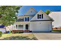 Charming two-story home with a well-manicured lawn and a two-car garage, perfect for Gathering living at 4828 Forest Highland Dr, Raleigh, NC 27604