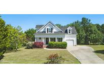 Charming two-story home featuring a well-manicured lawn and attached garage at 72 Cokesbury Park Ln, Fuquay Varina, NC 27526