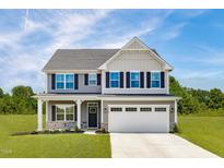 Charming two-story home with gray siding, black shutters, and a well-manicured front lawn at 812 Walker Ridge Way, Willow Springs, NC 27592