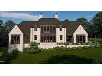 Stunning home with brick facade, dark trim and elegant landscaping provides privacy and curb appeal at 8413 Portmarnock Ct, Wake Forest, NC 27587