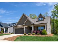 Charming single-Gathering home with a manicured lawn, inviting porch, and a two-car garage at 1007 Fairhaven Dr, Mebane, NC 27302