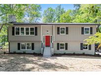 Charming two-story home featuring a bright red front door and manicured landscaping at 1514 Goodwin Rd, Durham, NC 27712