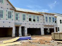 New construction townhome featuring a front-facing garage and multiple windows at 178 Nimble Way # 221, Clayton, NC 27520