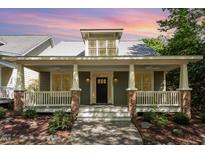 Charming home with a inviting front porch featuring brick accents and a well-manicured garden at 2106 Cloud Cover Ln, Raleigh, NC 27614