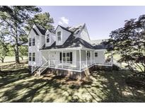 Charming two-story home with a covered front porch and well-maintained lawn and mature trees at 2122 Pleasant Hill Rd, Rocky Mount, NC 27801