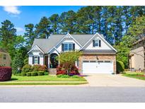 Charming home featuring manicured landscaping, a two-car garage, and stone accents on the exterior at 215 Terrell Dr, Rolesville, NC 27571