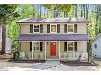Charming two-story home with a inviting front porch and a bright red front door at 2806 Shaftsbury St, Durham, NC 27704