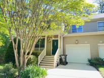 Charming townhome with a well-maintained front yard and a one car garage at 301 Charleston Ln, Chapel Hill, NC 27517