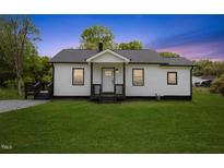 Charming single-story home with a well-maintained lawn and inviting front porch at 326 W Gilbreath St, Graham, NC 27253