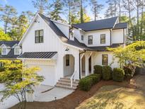 Charming two-story home featuring white siding, black trim, and a welcoming front porch at 3316 Milton Rd, Raleigh, NC 27609