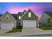 Charming home featuring a two-car garage, well-manicured lawn, and inviting curb appeal at 518 Judge Ct, Durham, NC 27703
