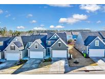 Exterior shot of attractive homes with well-maintained lawns and colorful facades at 518 Judge Ct, Durham, NC 27703