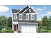 Charming two-story home with stone accents and a welcoming red front door at 525 Morning Light Dr # 33, Angier, NC 27501