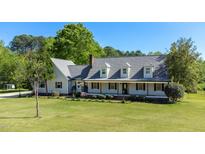 Charming two-story home featuring a welcoming front porch and lush, green lawn at 530 Turlington Rd, Dunn, NC 28334