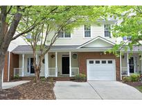Charming two-story townhouse with a brick garage, cozy porch, and well-maintained landscaping at 6022 Four Townes Lane Ln, Raleigh, NC 27616