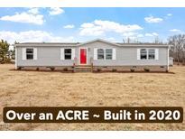 Charming single-story home featuring a bright red front door and situated on a spacious lot at 7289 Nc 561, Louisburg, NC 27549