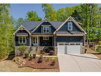 Beautiful craftsman-style home with a well-manicured lawn and inviting front porch at 104 Blue Finch Ct, Youngsville, NC 27596