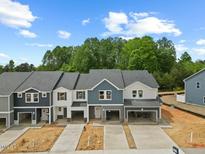 New townhomes feature modern designs, attached garages, and beautiful landscaping at 1048 Winding Spring Dr, Mebane, NC 27302