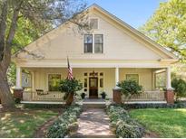 Charming home featuring a large front porch with columns and landscaped yard at 109 N Hassel St, Hillsborough, NC 27278