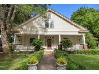 Charming home with a wide front porch, columns, and a beautifully landscaped yard at 109 N Hassel St, Hillsborough, NC 27278