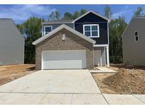 New construction home featuring a brick accent over the garage and a two-car driveway at 130 N Keatts Winner Ct, Wilson's Mills, NC 27520