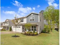 Charming home with a two-car garage, landscaped front yard, and welcoming curb appeal on a beautiful day at 130 Stromness Path, Clayton, NC 27527