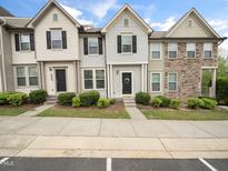 Charming townhome exterior featuring varied siding and stone accents, with a well-manicured lawn and dark shutters at 14315 Foxcroft Rd, Raleigh, NC 27614