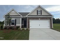 Charming single-Gathering home with stone accents, a two-car garage, and a well-manicured lawn at 182 E Victory View Ter, Smithfield, NC 27577