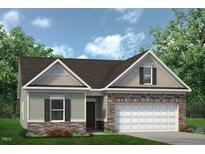 Charming single-Gathering home with stone accents, attached garage and a cozy, well-manicured front lawn at 182 E Victory View Ter, Smithfield, NC 27577