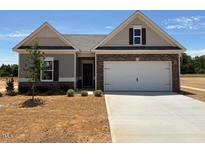Charming single-story home with a two-car garage and a well-manicured front yard at 182 E Victory View Ter, Smithfield, NC 27577