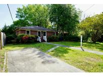 Charming brick home with a well-manicured lawn and ample parking space at 315 Clark St, Durham, NC 27701
