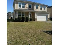 Charming two-story home featuring a well-maintained lawn and attached two-car garage at 3513 Diamond Springs Dr, Raleigh, NC 27610