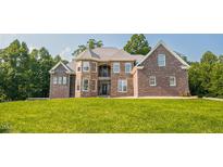 Stunning brick home with meticulously manicured lawn and stone accents at 3704 Hesters Store Rd, Hurdle Mills, NC 27541