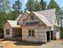 New construction home showing roof sheathing and framing, with windows and covered porch at 485 Chapel Ridge Dr, Pittsboro, NC 27312