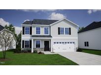 Charming two-story home featuring a two-car garage and a well-manicured front yard at 75 Cordoba Dr, Franklinton, NC 27525