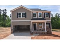Two-story home featuring stone accents, a two-car garage, and a neutral color scheme at 75 Cordoba Dr, Franklinton, NC 27525
