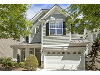 Charming home featuring a two-car garage, round window, and neutral toned exterior at 7728 Cape Charles Dr, Raleigh, NC 27617
