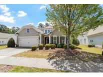Charming single-Gathering home featuring a manicured front yard and attached two-car garage at 792 Eldridge Loop, Cary, NC 27519