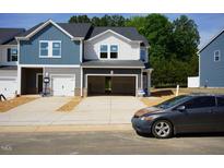 New two-story townhouse with open garage and modern design elements at 1046 Winding Spring Dr, Mebane, NC 27302