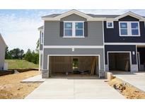 New construction townhome featuring a two-car garage and light gray horizontal siding at 1054 Winding Spring Dr, Mebane, NC 27302