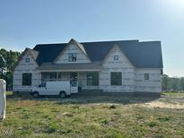 New construction home showing the exterior with a work van parked nearby at 11226 Old Beulah Rd, Kenly, NC 27542